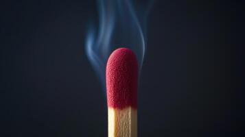 A matchstick with a red tip is shown photo