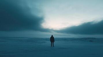 A person standing in the middle of a snowy field photo