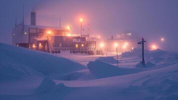 A research station sits in a snowy landscape, dimly lit by artificial lights while snow falls heavily around it. Strong winds and low visibility create a stark, wintry atmosphere during the night. photo