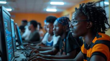 Young adults focus intently on their screens while coding in a lively computer lab setting, showcasing collaboration and learning in the evening light. photo