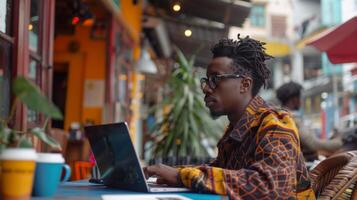 A young man works intently on his laptop at a lively cafe adorned with colorful decor. The atmosphere is filled with warmth and creativity. photo