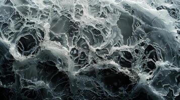 Intricate patterns and textures resemble water movement or geological formations beneath a surface. Soft lighting enhances the contrast and depth, evoking a sense of mystery. photo