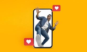A person joyfully interacts with a smartphone, showing enthusiasm for social media and texting. The colorful background emphasizes the themes of love and connection in digital communication. photo