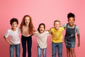 Portrait of multiethnic schoolkids smiling over pink background photo