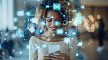 A young woman is absorbed in her smartphone, smiling as she interacts with various digital communication icons floating around her in a bright indoor space filled with soft lighting. photo