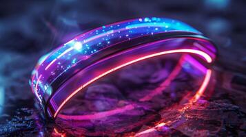 A sleek, futuristic bracelet lies on a textured surface, glowing with vivid blue and pink lights. The design highlights an artistic fusion of technology and modern aesthetics in a captivating way. photo