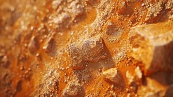 Close up view of a rugged terrain featuring orange soil and various sizes of stones, illuminated by soft, natural light on a clear day. photo
