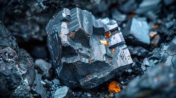 A large mineral specimen rests among smaller stones, revealing sharp edges and a rich array of colors. Natural light highlights its details and enhances the beauty of the surrounding geology. photo