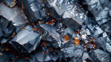 Close up display of mineral crystals highlighting sharp edges and reflective surfaces with hints of orange from embedded materials, creating an intriguing visual contrast. photo