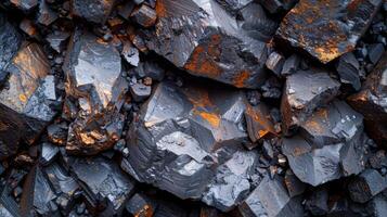Close up view of rough mineral rock textures displaying a shiny, metallic surface with contrasting orange streaks, captured in natural light, showcasing geological diversity. photo