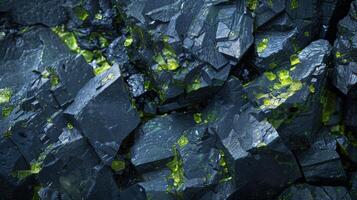 The image showcases a detailed view of dark mineral rock formations featuring striking green highlights. The unique textures and colors reveal the beauty of geological structures found in nature. photo