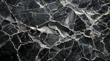 Highly detailed texture reveals a rock surface filled with unique cracks and patterns, emphasizing the beauty of natural geology in muted tones. photo