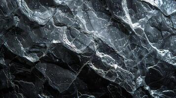 A striking dark marble surface reveals a complex pattern of veining and textures, highlighting the natural elegance and rich variations of the stone suitable for luxury decor and design. photo
