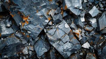 Examining the detailed surfaces of large fragments of metallic minerals with sharp edges, showcasing a mix of gray and rusty orange hues under natural light. photo