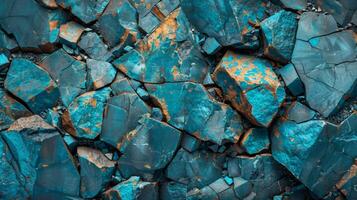 Intricate blue and orange mineral rocks cover the ground, displaying unique patterns and textures that highlight natural geological formations under bright sunlight. photo