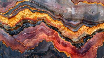 Intricate formations of agate stone highlight vibrant colors such as reds, oranges, and blacks. The smooth, layered textures reveal the natural beauty of mineral deposits found in various locations. photo