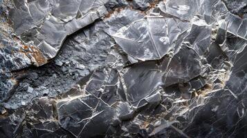 Close up view of dark grey mineral shards showcasing their sharp edges and distinct layers, highlighting the natural beauty and complexity of geological formations photo