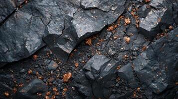 Rocky terrain exhibits a mix of dark minerals and scattered metallic fragments, highlighting the natural formations and varying textures under sunlight, creating a visually striking effect. photo