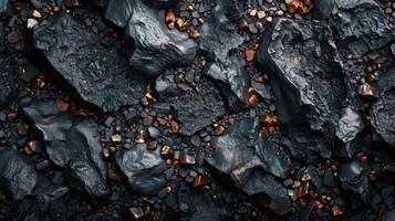 A rugged landscape displays a textured surface of dark rock, interspersed with gleaming copper colored minerals that reflect natural light, creating a striking visual. photo