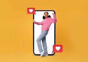 A cheerful person interacts with a smartphone, surrounded by social media heart icons. The bright background highlights the importance of technology in modern dating and communication. photo