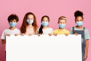 Diverse kids in face masks holding empty poster on pink background, mockup for design photo
