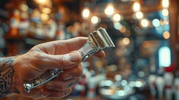 A person is gripping a vintage straight razor, highlighting the tool of choice for barbers. The barbershop features warm lights and a rustic setting, creating an inviting atmosphere. photo