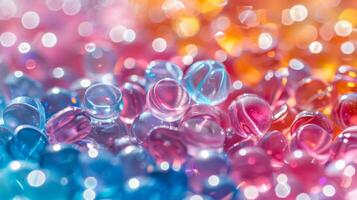 Close up view showcases an array of colorful glass beads blending shades of blue, pink, and orange, reflecting light and creating a mesmerizing texture that captivates the eye. photo