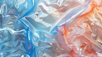 Crumpled plastic sheets in vibrant shades of blue and orange create an abstract texture, capturing light and creating reflections that enhance the visual interest of the materials. photo