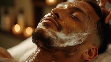 A man enjoys a rejuvenating facial treatment, soaking in a tranquil atmosphere with soft lighting and relaxing music while a professional applies a cleansing mask. photo