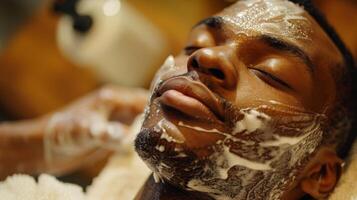 A young man enjoys a rejuvenating facial treatment at a spa, with cream applied to his face while he relaxes with eyes closed, experiencing tranquility and self care. photo