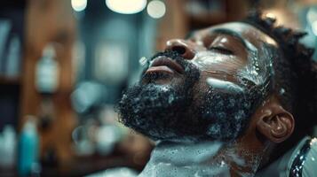 A man relaxes in a barber chair as he enjoys a soothing beard grooming session, with rich lather and focused attention from the barber in a stylish environment. photo