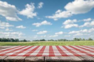 A picnic tablecloth on a wooden surface with a scenic sky background. photo