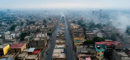 Aerial view of a cityscape with buildings and roads in foggy weather. photo