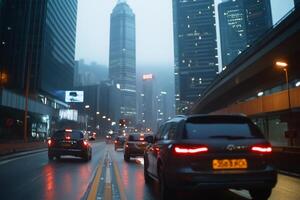 A cityscape at dusk with vehicles on a wet, illuminated road. photo