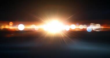 A bright light source creating a lens flare effect against a dark backdrop. photo