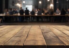 A wooden table in the foreground with people dining in the background. photo