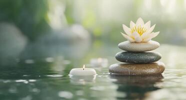 Tranquil scene with stacked stones, a lotus flower, and a floating candle. photo