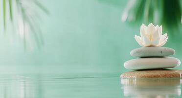 Serene arrangement of stones and a lotus flower on calm water. photo