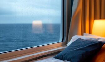 Cozy cabin interior with a rainy ocean view through the window. photo