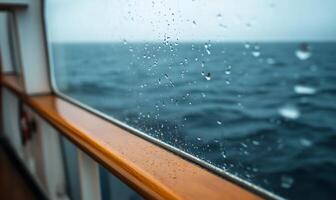 Rain droplets on a ship's window overlooking the ocean. photo