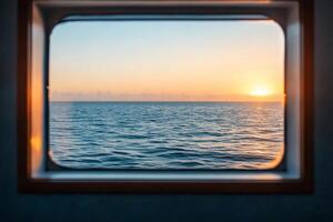 A tranquil view of the ocean at sunset through a window. photo