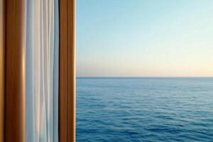 A serene view of the ocean from a window with flowing curtains. photo