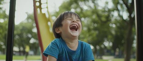 A joyful child laughs on a playground, surrounded by greenery, capturing the essence of happiness and innocence. photo