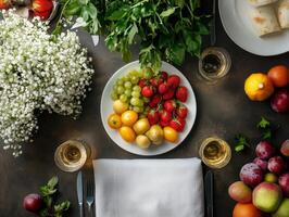 Fresh and Vibrant Fruit Platter with Greenery and Flowers on Rustic Table Setting photo