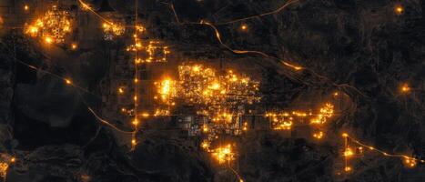 Global Economic Crisis Oil Concept. Brightly lit clusters of lights against a dark background, resembling a nighttime aerial view of a city or urban landscape. photo