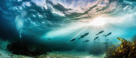 Underwater scene with sunlight penetrating the surface, illuminating fish swimming near a reef, creating a tranquil ocean atmosphere. photo