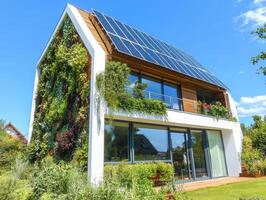 A modern eco-friendly house featuring solar panels and lush greenery, blending sustainability with contemporary design under a clear blue sky. photo