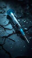 Syringe lying on wet cracked surface representing drug addiction issues photo