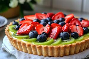 Freshly baked fruit tart with kiwi, blueberries and strawberries on a pastry cream base photo