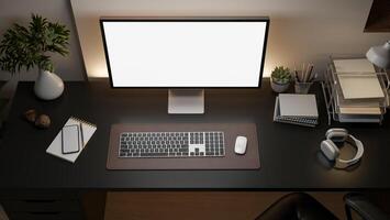 A white screen computer on the black table with decorative items, Workspace from above. photo